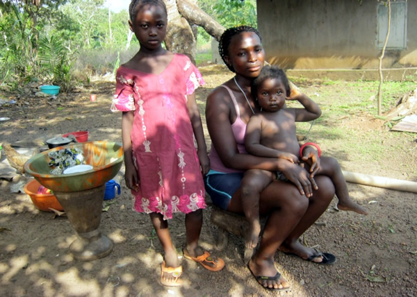 Kadiatu and her two daughters in their community